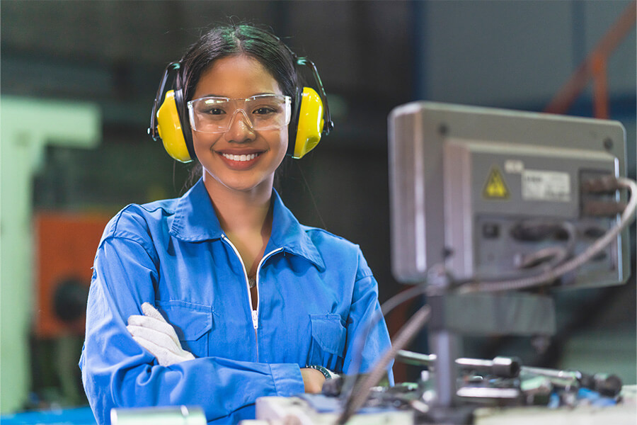 Female technician smiling at her work station