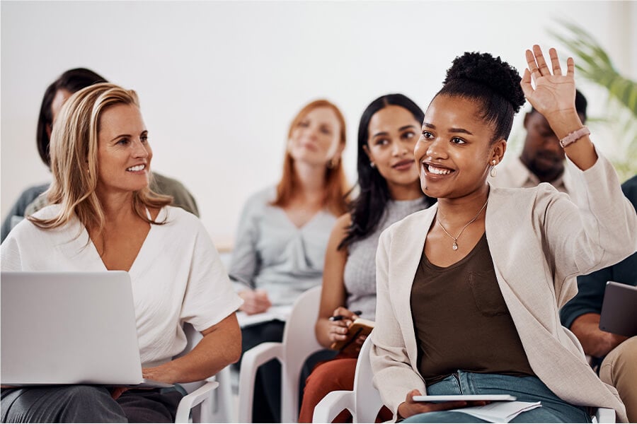 Woman raising hand in meeting