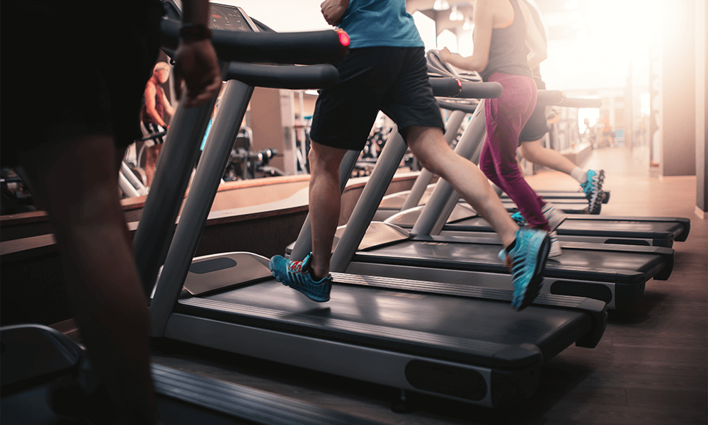 Gym members running on treadmill 