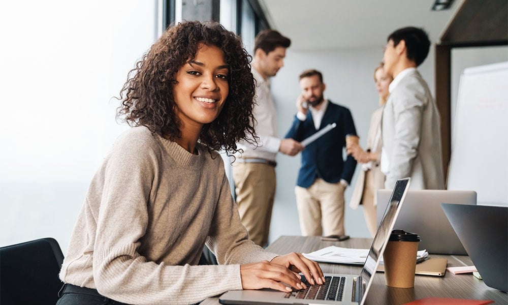 Young woman smiling at her office