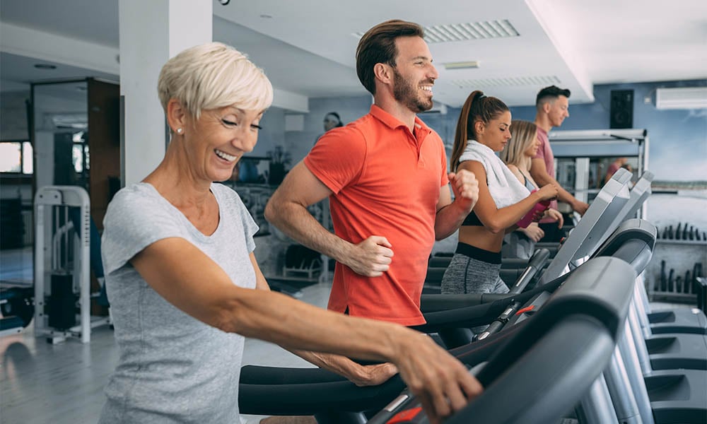 Group of people running on treadmills in the gym