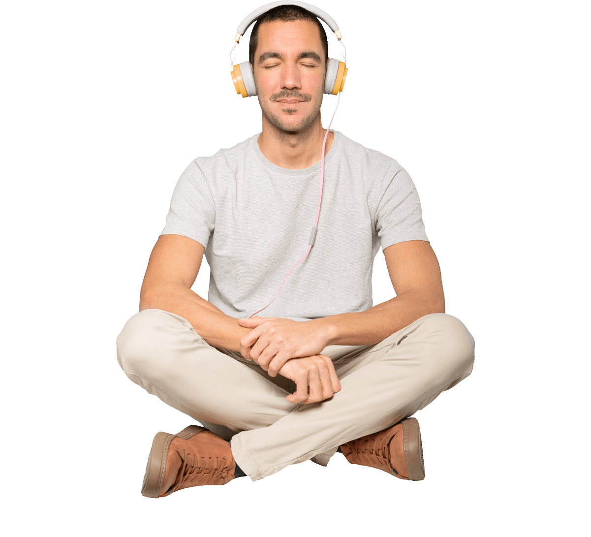 Man meditating with legs crossed wearing headphones