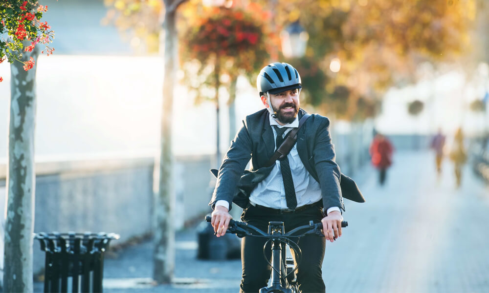 Man smiling while riding a bike to work